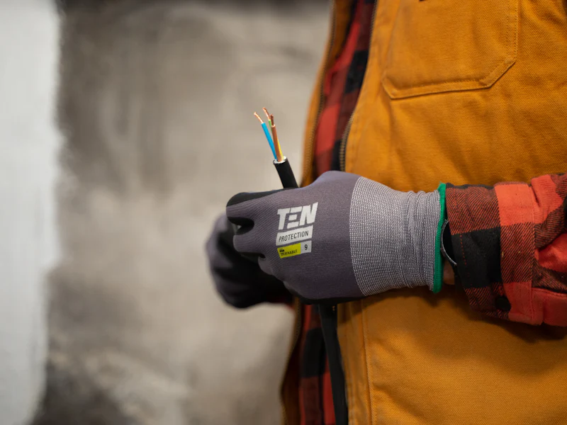 Gloved hands working on an electrical cable